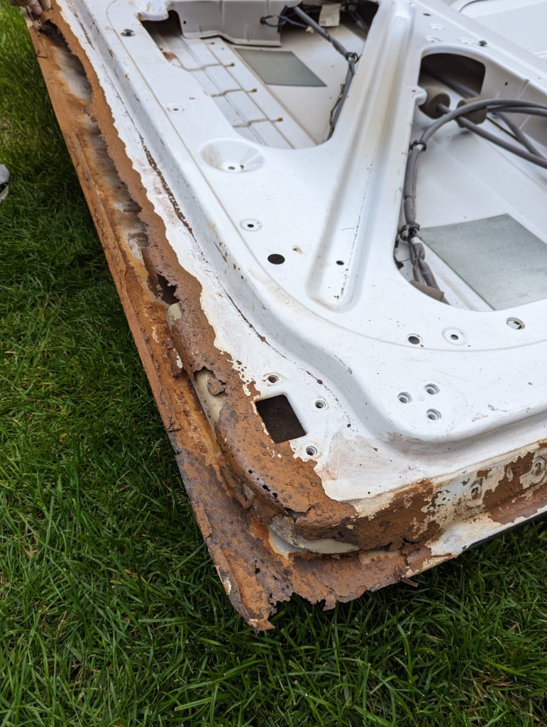 our very rusted sprinter van door before we fixed it