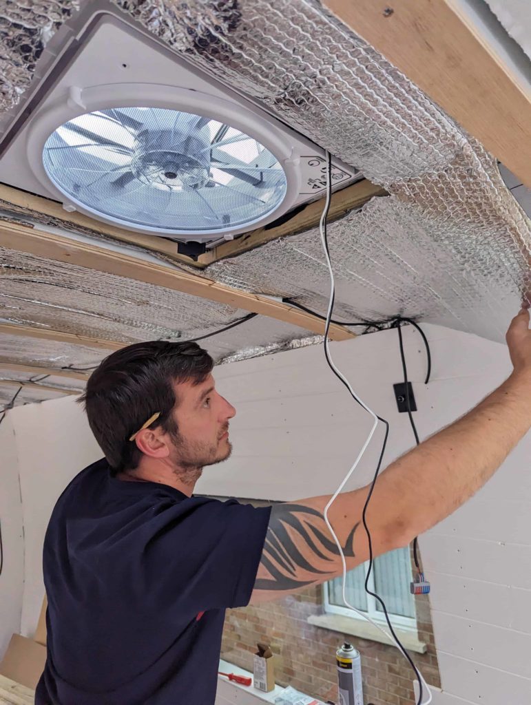 Andrew fitting the insulation around our MaxxAir Fan.