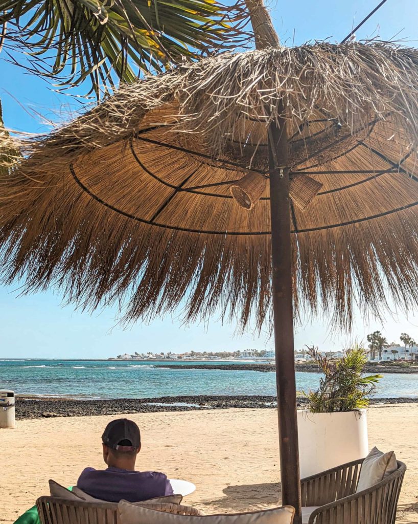 Views to the sandy beach and blue waters from Waikiki Beach Bar, Corralejo.