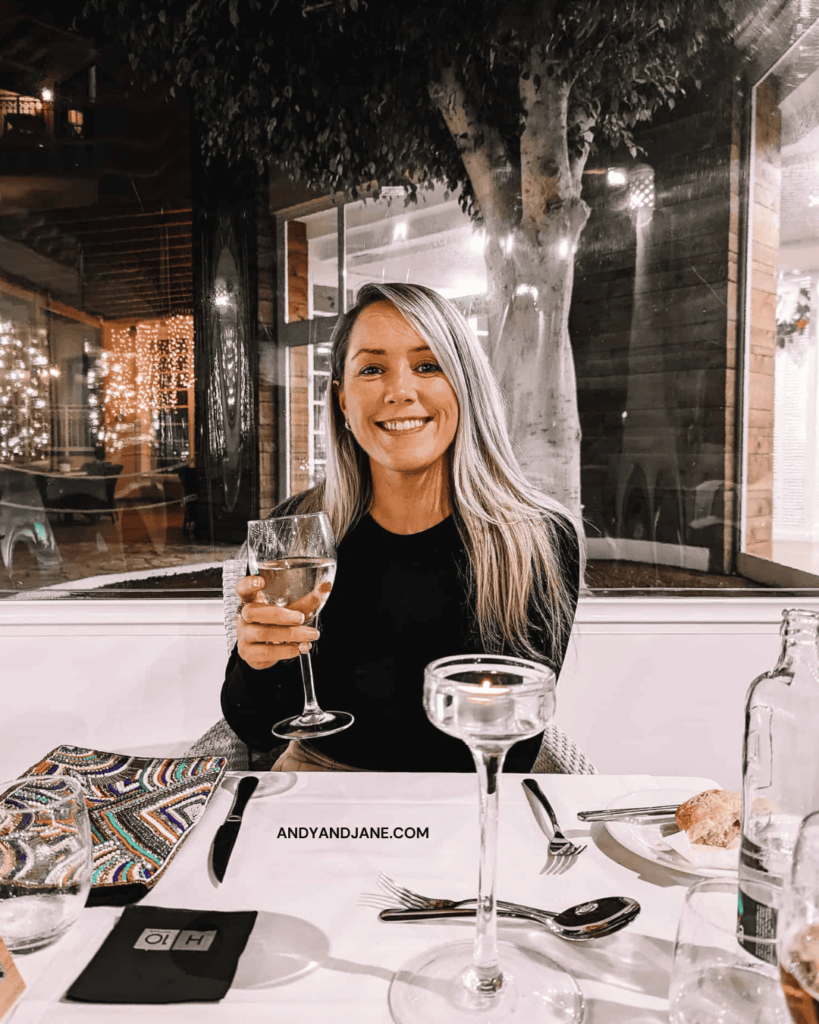 Jane holding a glass of wine in the Privilege El Jable Restaurant in H10 Playa Esmeralda.