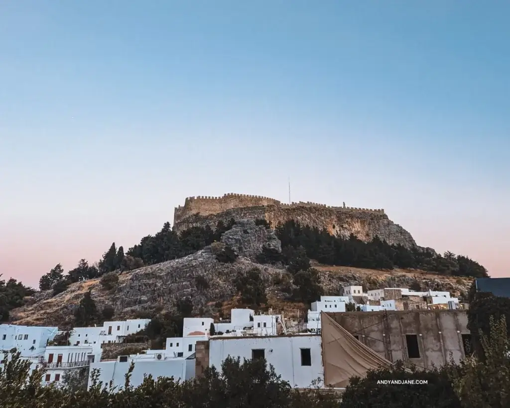 The Acropolis of Lindos at sunset, towering over the village of Lindos.