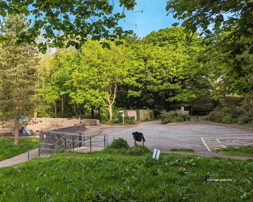 The empty car park in Duncans Park, Lisburn - surrounded by trees & beside a playpark.