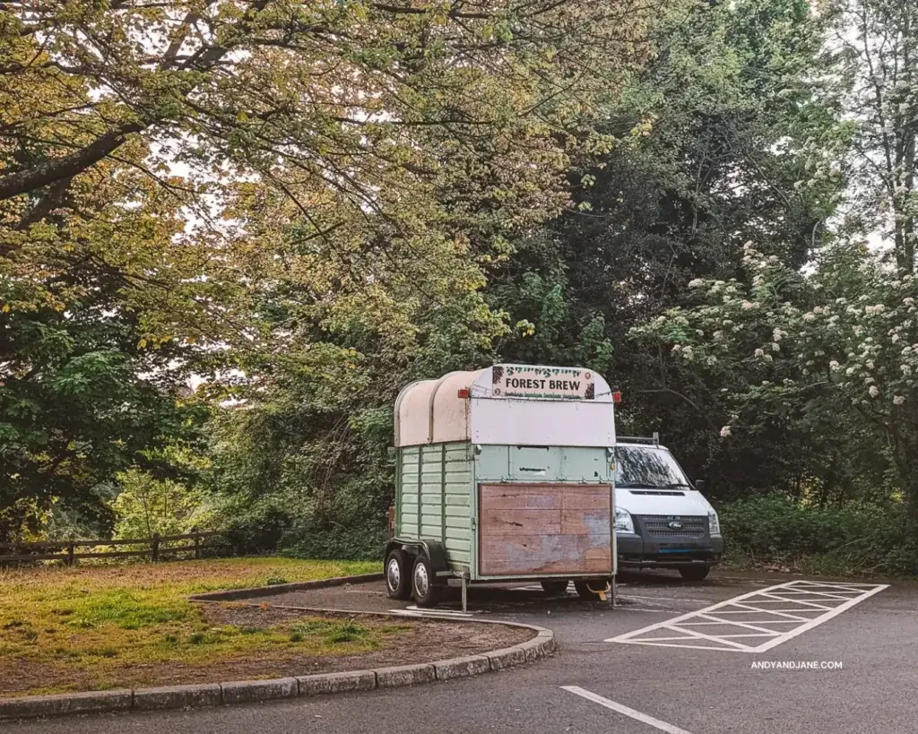 A coffee van called 'Forest Brew', sitting in the parking lot of Belvoir Forest Park surrounded by trees.