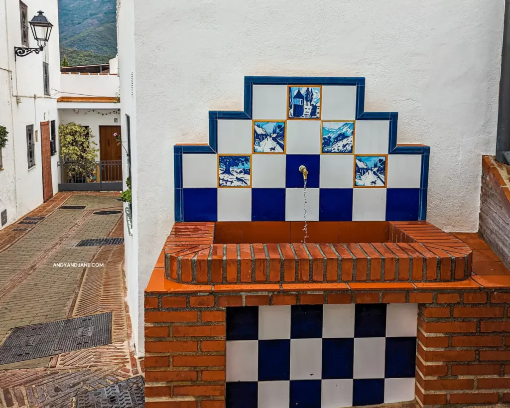 A water fountain in Istan with the tap running and the signature blue & white tiles with small paintings on them.