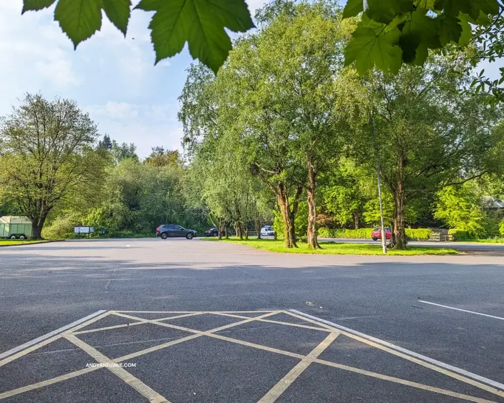 The spacious car park of Belvoir Forest Park with a few cars parked.