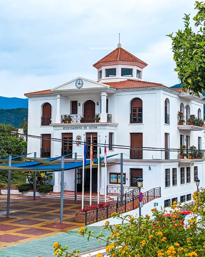 The town hall of Istan with an orange turret & clock at the top.