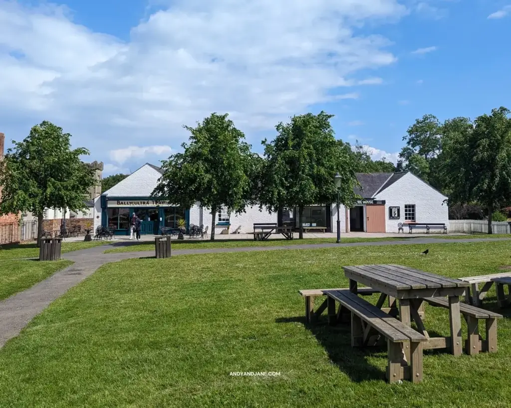 Picnic benches at the Ulster Folk Museum on the grass in front of BallyCultra Tearoom .