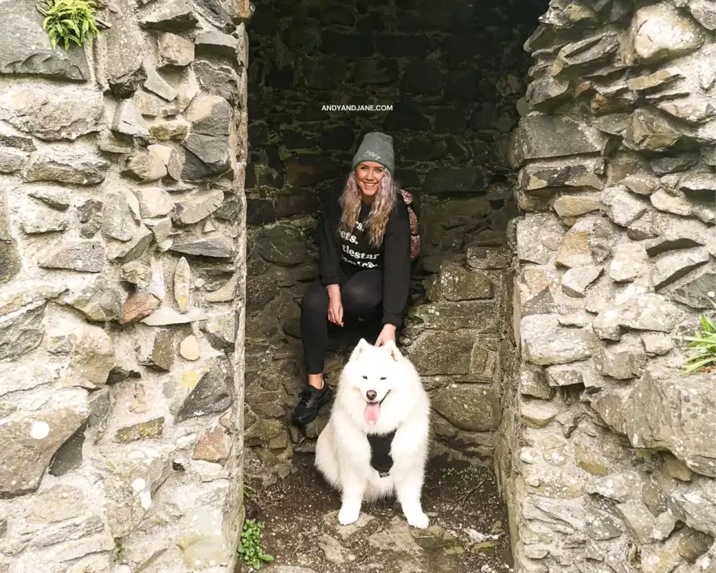 Jane and Luka sitting in the ruins of a stairway at Inch Abbey.