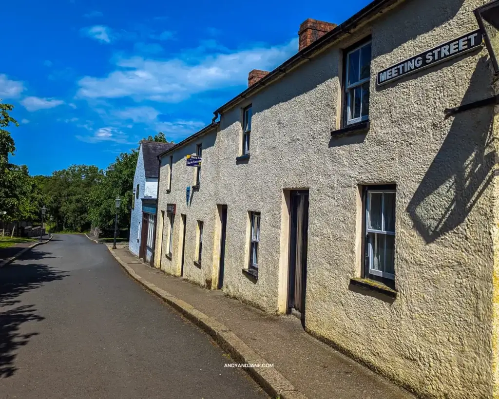 An old street with terraced houses painted yellow.