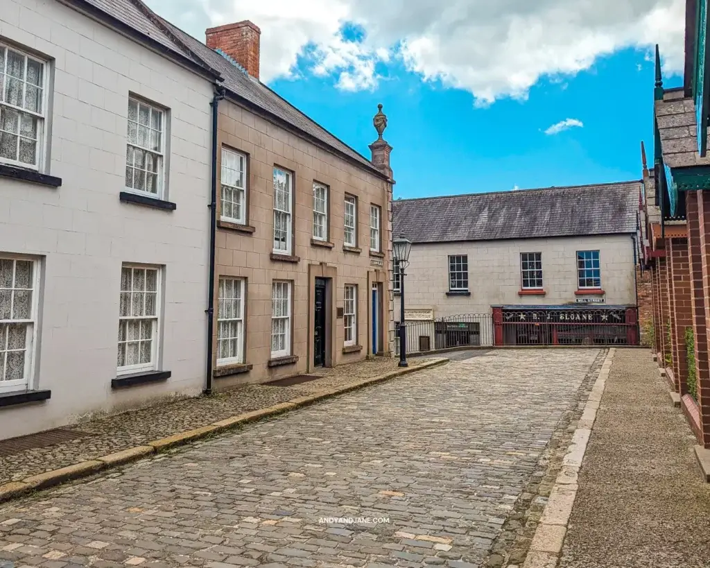 A cobbled street with old historical houses each side.