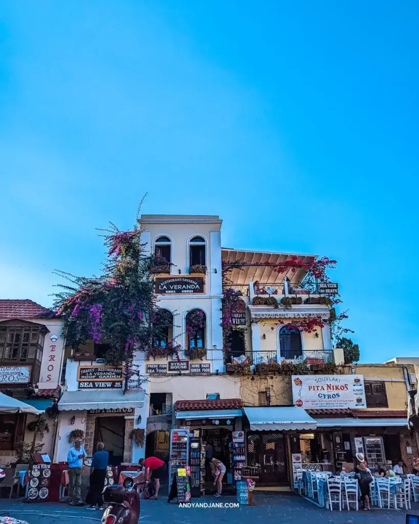 Flower covered buildings & restaurants in Rhodes Town.