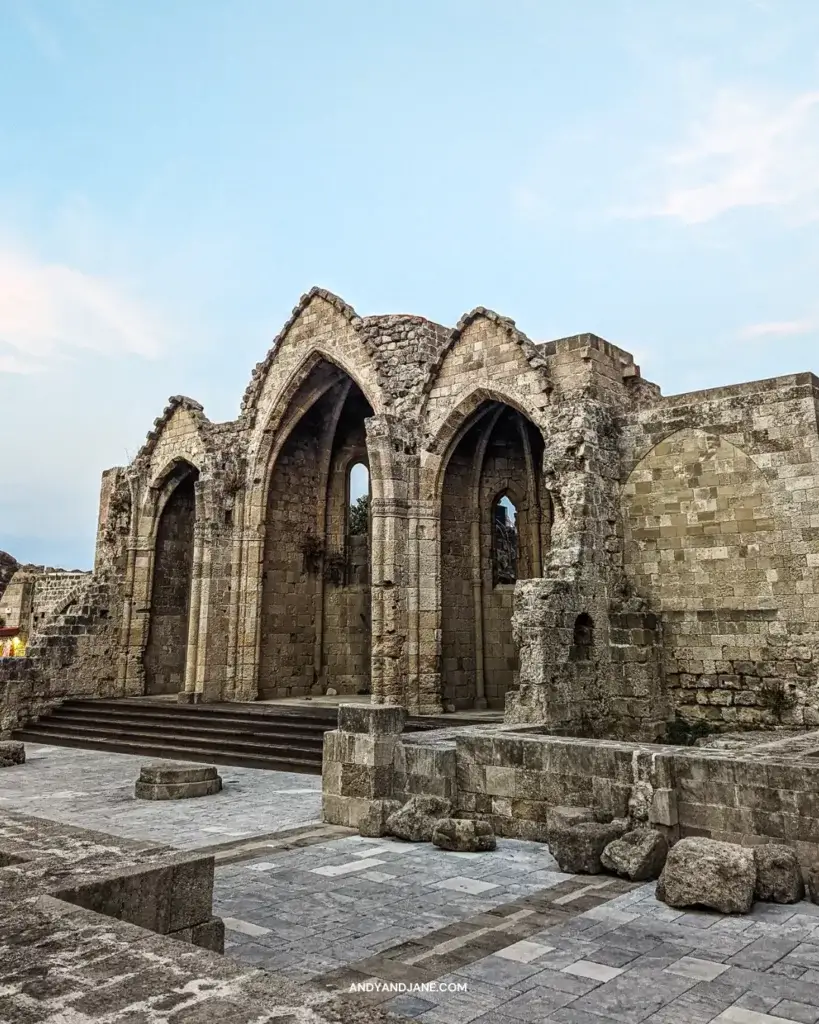 The ruins of the Church of the Virgin Mary of The Burgh in Rhodes. A large stone ruin with 3 archways.