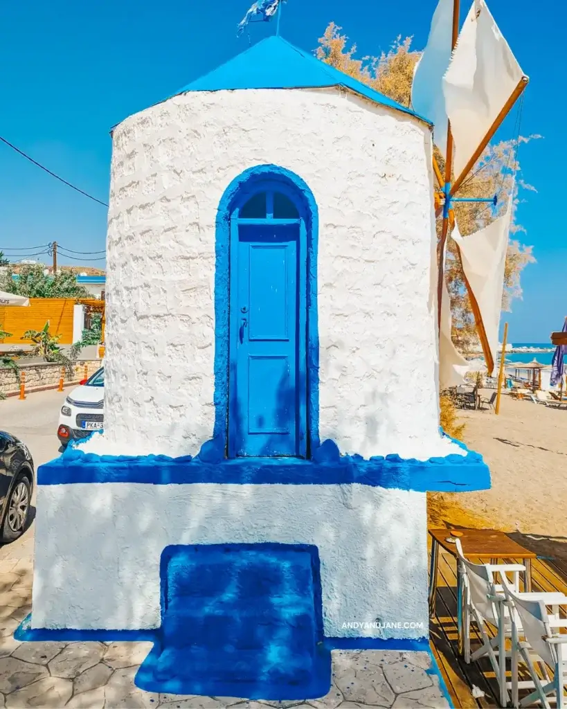 A small blue and white windmill with a blue door at Stegna Beach, Rhodes.