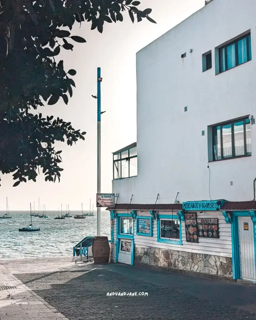 A fish restaurants with blue door and windowframes overlooking the ocean in Corralejo.