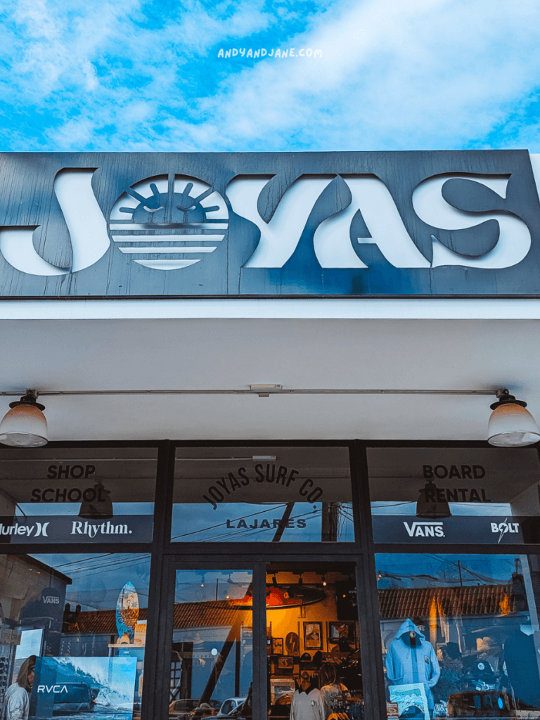 Exterior view of Joyas Surf Co. shop in Lajares, featuring the store name and windows displaying surfboards and apparel.